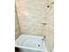 This bathroom features a shower over tub and tile walls at 2655 Hempstead Dr, Lakeland, FL 33801