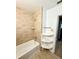 This bathroom features a shower over tub and a corner shelf at 2655 Hempstead Dr, Lakeland, FL 33801