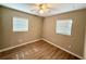 This bedroom features two windows with blinds and vinyl floors at 2655 Hempstead Dr, Lakeland, FL 33801