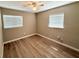 This bedroom features two windows with blinds and vinyl floors at 2655 Hempstead Dr, Lakeland, FL 33801