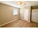 This bedroom features a ceiling fan and vinyl floors at 2655 Hempstead Dr, Lakeland, FL 33801