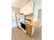 This kitchen features white appliances and cabinets and includes a breakfast bar for additional seating at 2655 Hempstead Dr, Lakeland, FL 33801