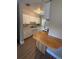Bright kitchen featuring white cabinets, a breakfast bar, and modern flooring at 2655 Hempstead Dr, Lakeland, FL 33801