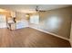 Open floor plan showing a living room with wood-look flooring, a ceiling fan, and a view into the kitchen at 2655 Hempstead Dr, Lakeland, FL 33801