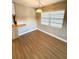 Wood-look flooring, natural light, and a pendant light fixture highlight this living room view at 2655 Hempstead Dr, Lakeland, FL 33801