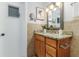 Bathroom featuring granite countertop, wood vanity, attractive mirror, and stylish fixtures at 2726 Cleveland Heights Blvd, Lakeland, FL 33803