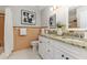 Bathroom featuring tiled walls, granite countertop, double sinks and a decorative mirror at 2726 Cleveland Heights Blvd, Lakeland, FL 33803