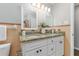 Bathroom featuring granite countertops, double sinks, stylish lighting, and decorative elements at 2726 Cleveland Heights Blvd, Lakeland, FL 33803