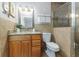 Bathroom showcasing a granite countertop vanity, tiled walls, and a glass-enclosed shower with mosaic tile accents at 2726 Cleveland Heights Blvd, Lakeland, FL 33803