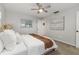 Cozy bedroom featuring a ceiling fan, neutral walls, plush carpet, and comfortable bed with decorative pillows and a throw blanket at 2726 Cleveland Heights Blvd, Lakeland, FL 33803