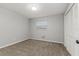 Bedroom features carpeted floors, neutral walls, a window, and a closet for storage at 2726 Cleveland Heights Blvd, Lakeland, FL 33803