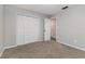 Bedroom showing carpeted floors, a closet, and natural light streaming through a window at 2726 Cleveland Heights Blvd, Lakeland, FL 33803