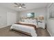 Cozy bedroom features a ceiling fan, window, large closet, and neutral decor and carpeting at 2726 Cleveland Heights Blvd, Lakeland, FL 33803