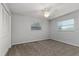 Bright bedroom with neutral walls, carpeted floors, a ceiling fan, and two windows letting in natural light at 2726 Cleveland Heights Blvd, Lakeland, FL 33803