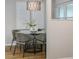 Modern dining area featuring a glass table with seating for four and a contemporary light fixture at 2726 Cleveland Heights Blvd, Lakeland, FL 33803