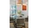 Bright dining area with views and a stylish pendant light fixture, perfect for entertaining guests at 2726 Cleveland Heights Blvd, Lakeland, FL 33803