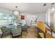 Bright dining room with modern light fixtures, hardwood floors, and views into the living room at 2726 Cleveland Heights Blvd, Lakeland, FL 33803