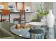 Stylish dining area with a glass-top table and seating, adjacent to a kitchen with counter seating at 2726 Cleveland Heights Blvd, Lakeland, FL 33803
