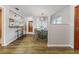 Bright dining room with modern light fixtures, hardwood floors, and views into the kitchen at 2726 Cleveland Heights Blvd, Lakeland, FL 33803