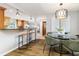 Bright dining room with modern light fixtures, hardwood floors, and views into the kitchen at 2726 Cleveland Heights Blvd, Lakeland, FL 33803