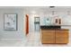 Hallway view of tile floor, cabinet storage, wall art, and doorway to laundry area with washer and dryer at 2726 Cleveland Heights Blvd, Lakeland, FL 33803
