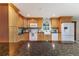 Bright kitchen features stainless steel appliances, stone countertops, wood cabinets, and tiled backsplash at 2726 Cleveland Heights Blvd, Lakeland, FL 33803