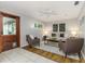 Inviting living room features lots of light, neutral colors, ceiling fan, and door to outdoor space at 2726 Cleveland Heights Blvd, Lakeland, FL 33803