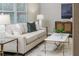 Bright living room featuring a comfortable sofa, stylish coffee table, and natural light from the window at 2726 Cleveland Heights Blvd, Lakeland, FL 33803