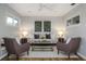 Cozy living room features neutral decor, a ceiling fan, and plenty of natural light from two large windows at 2726 Cleveland Heights Blvd, Lakeland, FL 33803