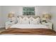 Bright main bedroom offers a window view and two nightstands with lamps flanking the bed at 2726 Cleveland Heights Blvd, Lakeland, FL 33803