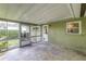 A spacious screened porch with access to the backyard, offering an ideal space for relaxation at 2726 Cleveland Heights Blvd, Lakeland, FL 33803