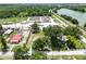 This aerial view reveals an establishment bordered by lush vegetation and a serene lake at 330 Diesel Rd, Mulberry, FL 33860