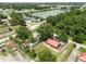 A home is revealed in this lush aerial shot, nestled near serene lake and winding train tracks at 330 Diesel Rd, Mulberry, FL 33860