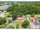 This aerial view captures a collection of homes set amidst lush greenery and beside a lake at 330 Diesel Rd, Mulberry, FL 33860