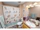 Bathroom showcasing a tiled shower, seashell-themed decor, and a modern vanity with ample countertop space at 330 Diesel Rd, Mulberry, FL 33860