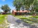 Charming home with mature trees, landscaping, and a long driveway at 330 Diesel Rd, Mulberry, FL 33860