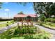 Inviting log home with red metal roof, lush landscaping, and a charming front yard at 330 Diesel Rd, Mulberry, FL 33860