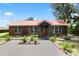 Well-maintained log cabin home with a red metal roof and landscaped front yard at 330 Diesel Rd, Mulberry, FL 33860
