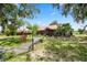 Beautifully landscaped front yard with a charming home and mature trees providing shade at 330 Diesel Rd, Mulberry, FL 33860