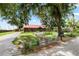 Charming front yard featuring mature trees, landscaping, and a driveway leading to the home at 330 Diesel Rd, Mulberry, FL 33860