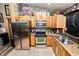Functional kitchen with stainless steel appliances, granite countertops, and warm, wooden cabinets at 330 Diesel Rd, Mulberry, FL 33860