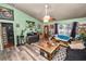 Comfortable living room with wood-look floors, a ceiling fan, and a cozy seating area at 330 Diesel Rd, Mulberry, FL 33860
