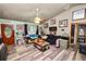 Inviting living room with wood-look floors, a large window, and a ceiling fan at 330 Diesel Rd, Mulberry, FL 33860
