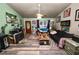 Cozy living room with hardwood floors, bright walls, a ceiling fan, and warm, natural lighting at 330 Diesel Rd, Mulberry, FL 33860
