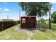 Exterior view of the shed on the property with double doors and a window at 330 Diesel Rd, Mulberry, FL 33860