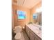 Bathroom with white vanity, toilet, and framed mirror at 3315 Cross Fox Dr, Mulberry, FL 33860