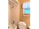 Bathroom featuring a shower over tub and a window at 3315 Cross Fox Dr, Mulberry, FL 33860