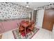 Dining area with a table and chairs, along with floral wallpaper and striped walls at 3315 Cross Fox Dr, Mulberry, FL 33860