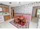 Dining area with a table and chairs, along with floral wallpaper and striped walls at 3315 Cross Fox Dr, Mulberry, FL 33860