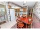 Kitchen with wood cabinets and white appliances, along with a dining area table and chairs at 3315 Cross Fox Dr, Mulberry, FL 33860